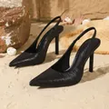 Elegant black slingback stiletto heels with a pointed toe presented on beach sand. - 35 / Black