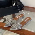Detail view of rhinestone bow and crystal heel on elegant pointed-toe mules - 35 / Silver Flat Heel (1CM)