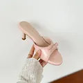 Elegant pink kitten heel mules featuring a bow accent and crocodile skin texture for women. - 34 / Stone Pattern Pink