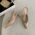 Detailed view of the sparkling crystal embellishments on elegant nude patent leather heels - 35 / Apricot