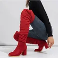 Side view detail of red suede over-the-knee boots with chunky high heels and elastic fit. - 38 / Red