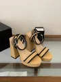 Detailed view of beige raffia platform sandals with chunky heels and black strap accents - 35 / Tan
