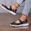 Macro view of colorful woven elastic band flat sandals for women shown on a model - Space Dye Black