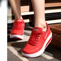 Detailed view of red platform rocking sneakers featuring thick soles and a lace-up design - 35 / Red