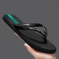 Minimale schwarze Flip-Flops mit blaugrünem Akzent für Herren und Damen am Strand - 39 / Schwarz