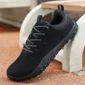 Black casual walking shoe with a wide toe box and soft sole on an outdoor ground. - 37 / Black