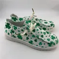Detailed side view of women's white canvas loafers with green shamrock clover pattern print - 38 / Light Green
