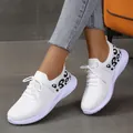 Detailed shot of stylish white mesh women's sneakers featuring black leopard print - 36 / White
