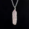 Detailed close-up of a handmade tree of life wire-wrapped rose quartz crystal necklace - Small Rose Quartz