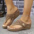 Primer plano de sandalias de cuña marrón con parte superior cortada con láser. - Marrón