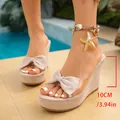 Detailed view of 10cm wedge heel height on elegant beige bow sandals - 35 / Off-white (901)
