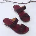 Detailed view of women's burgundy wedge sandals with floral accents and sparkling rhinestones - 35 / Burgundy