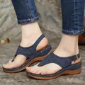 Detailed side view of women's navy blue embroidered thong wedge sandals for summer wear - 35 / Blue