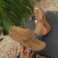 Detail showing brown wedge thong sandals with metallic sequins on a natural stone background. - 36 / Tan