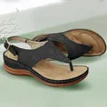 Detailed view of black T-strap wedge sandals with elegant wave-pattern stitching - 35 / Black