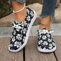 Women's black canvas slip-on shoes with white clover floral print and white sole - 36 / Black