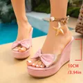 Detailed view of elegant pink bow wedge sandals featuring a 10cm high platform heel - 35 / Pink 901