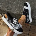 Macro detail of women's leopard and snakeskin print patchwork slip-on canvas shoes - 35 / Black