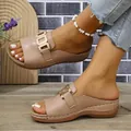 Detailed side view of beige peep-toe wedge sandals with golden buckle on model feet - 36 / Pink