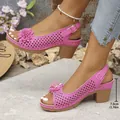 Elegant women's pink chunky heel sandals with flower detail and perforated design - Pink