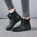 Close-up side view of women's black flat ankle boots in British Martin style - 35 / Black