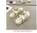 Detailed view of beige platform sandals with bow knot and Foshian branding on carpet - 35 / Beige