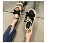 Detail showing bow-knot strap and comfortable platform sole of women's sandals. - 35 / Black