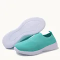 Close-up detail of turquoise fly-knit slip-on sneakers with white textured sole - Moon Blue