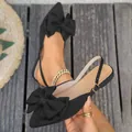 Elegant black pointed-toe flat sandals with oversized bow and adjustable slingback strap - 36 / Black