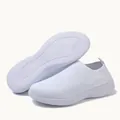 Detail view of lightweight white knit slip-on sneakers showing soft non-slip sole texture - White