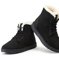 Close-up of black lace-up winter boots with thick white faux fur lining for warmth. - 36 / Black