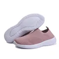 Detailed view of mauve flyknit slip-on sneakers featuring breathable mesh and white soles - 35 / Pink