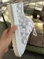 Detailed view of women's white mesh lace-up casual shoes featuring small floral embroidery. - 35 / White