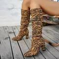 Fashionable tiger print high heel slouchy boots for women featuring a chunky heel design. - Leopard Print