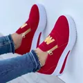 Close-up of red platform sneakers with gold side zipper and metallic 'M' detail - 35 / Red