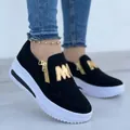 Detail view of women's black platform loafers featuring gold zipper and M logo - 35 / Black