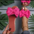 Detailed view of hot pink bow slides with elegant gold rhinestone trim. - 36 / Rose Red