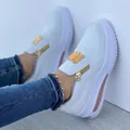 Detail view of white platform sneakers for women with gold zipper and W emblem - 35 / Off White