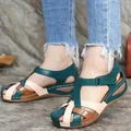Detailed view of women's retro wedge sandals with colorful cross-straps and round toe - 35 / Green
