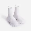 Detail view of white knitted sock boots with chunky platform lug soles for winter. - 35 / White