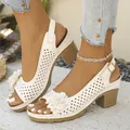 Close-up of white flower detail and perforated pattern on chunky heel sandals. - 36 / White