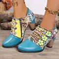 Detail view of ethnic floral ankle boots with blue leather toe and chunky stacked heel. - Teal