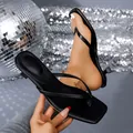 Close-up detail of black low-heel thong sandals featuring a square toe and fashion stiletto heel - 35 / Black