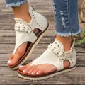 Detail view of off-white canvas thong sandals with rivets and back zipper closure - 36 / White