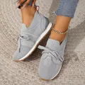 Stylish gray fly-knit women's sneakers shown on a model with denim jeans and anklet - 36 / Slate Gray
