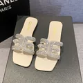 Elegant cream-colored flat slippers featuring a sparkling rhinestone buckle and square toe - 35 / Off White