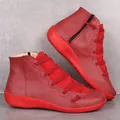 Side view of red leather casual short boots with decorative laces and side zippers - 35 / Red
