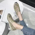 Detail view of golden mesh embroidered platform loafers with breathable floral design - 36 / Gold