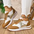 Close-up of stylish brown and white patchwork platform sneakers for women on wood floor - 36 / Tan