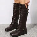 Close-up of brown lace-up knee-high knight boots with adjustable buckle straps - Dark Brown
